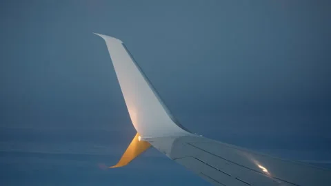 Erodynamic airplane winglet with glowing navigation light at twilight Stock Footage 325049776
