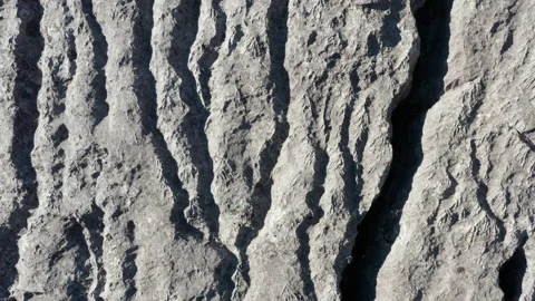 Erosion of bare wrinkled rock - texture of rough stone with grooves and furrowed Stock Footage 232517983