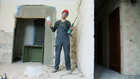 Erotic dance of the Builder with a puncher in hands and money Stock Footage 112008363