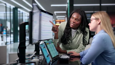 ERP Manager Coaching Colleague On Enterprise Software Using Laptop Stock Footage 345323474