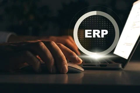 ERP system in use on laptop during night time with user focused on tasks Stock Photos