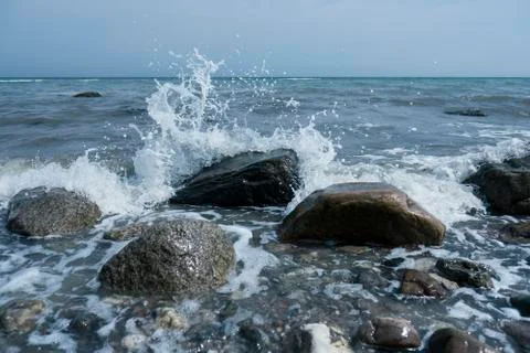 Erratic blocks in the surf Stock Photos