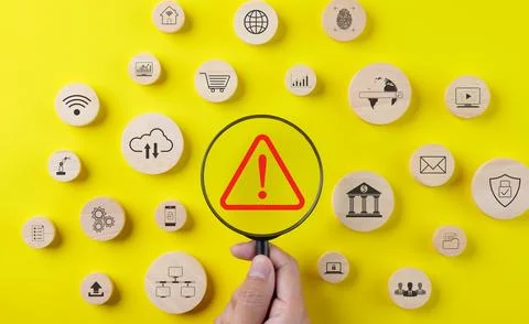 Error notification concept. Magnifying glass focusing red triangle caution. Stock Photos