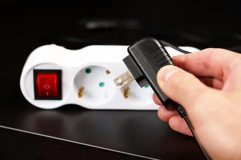 Error plugging an electrical plug into an outlet in a European hotel due to d Stock Photos