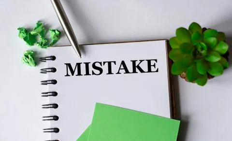 ERROR - word in a notebook on a white background with a pen, green pieces of Stock Photos