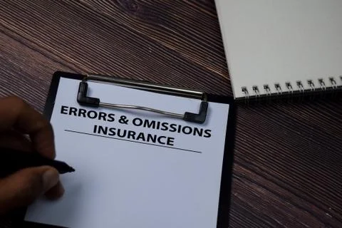 Errors &amp; Omissions Insurance write on paperwork isolated on wooden table. Stock Photos