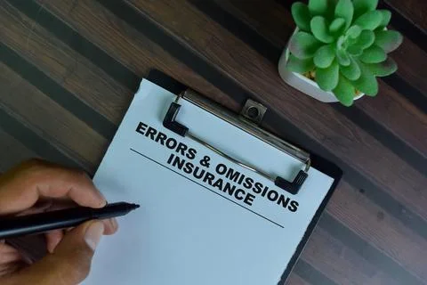 Errors &amp; Omissions Insurance write on a paperwork isolated on Wooden Table. 스톡 사진