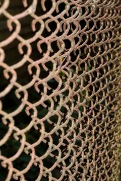 Erspective view of a rusty and dirty chained fence in the park - Old braided Stock Photos