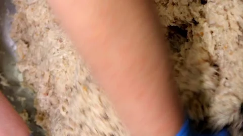 Ertical video. The chef's hands mix bread with minced fish and egg in a metal Video stock 248906476