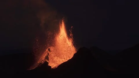 Erupting Volcano Spewing Glowing Lava into Dark Night Sky Stock Footage 346240620