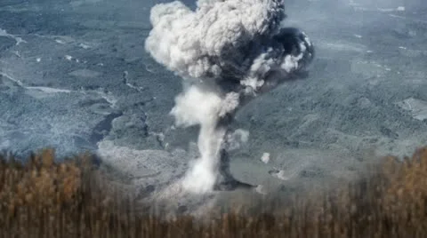 Erupting Volcano with Tall Grasses in foreground Stock Footage 11476068