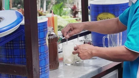 Es Kelapa Muda or young coconut ice, a popular Indonesian drink. Stock Footage 210373440