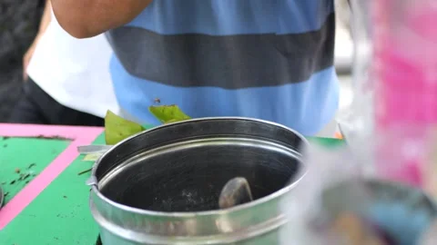 Es Puter Solo Seller serving customer. Traditional Javanese coconut ice cream  Stock Footage 247167295