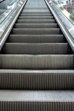 Escalator close up in modern station interior. Urban infrastructure concept. Stock Photos