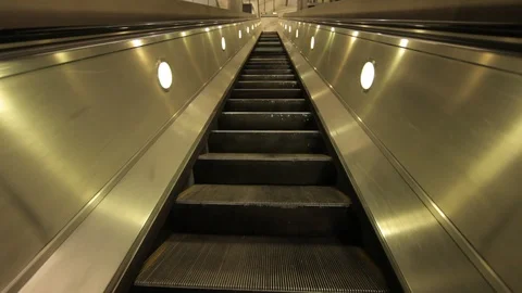Escalator down into Jubilee Line Underground station 3 Stock Footage 100590883