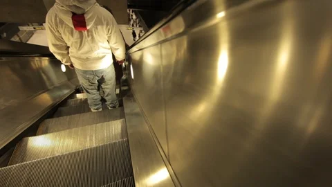 Escalator down into Jubilee Line Underground station pulsing lights Stock Footage 100590976