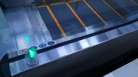 Escalator,an electric elevator in a shopping mall with a lighted arrow sign. Stock Footage 305499721
