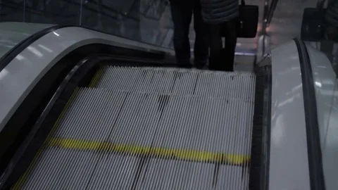 Escalator going up with two people. Using transport technology to easy move Video stock 76012088