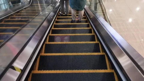 The escalator machine goes down. Go down slowly. In a busy shopping center. Stock Footage 247913829