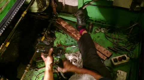 Escalator maintenance - Old man comparing a broken roller and a new roller Stock Footage 39567463