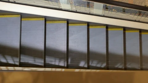Escalator in the mall close-up. In the background, people are out of focus for Stock Footage 100208212