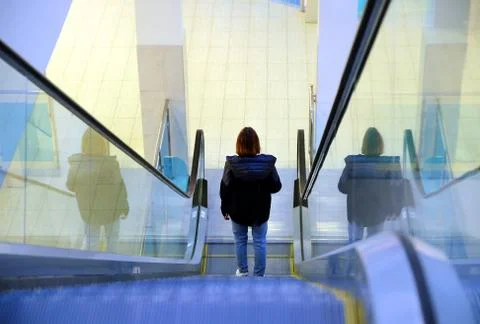 Escalator at the Mall. Modern interior of the shopping center. Silhouette of a Stock Photos