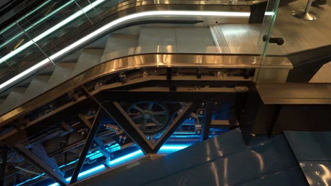 Escalator mechanism operates inside public building showing its internal gears Stock Footage 337544612