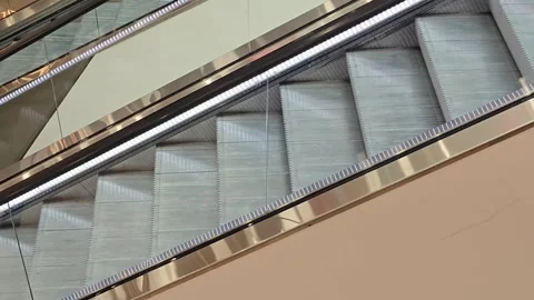 Escalator metal steps moving upward inside a building Stock Footage 344673799