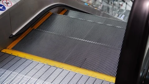 Escalator moving down on floor of building Stock Footage 89204376