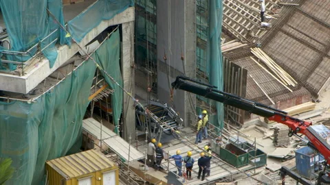 Escalator part is hoisted into building construction site Stock Footage 144724241