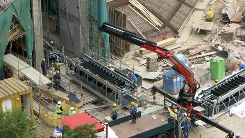 Escalator part is hoisted at a building construction site (time-lapse) Stock Footage 144724308