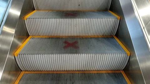 Escalator with red social distancing marks on the steps at mall - Covid 19 Stock Footage 141725292