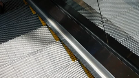 Escalator staircase moving down in the floor of modern building Stock Footage 93587046