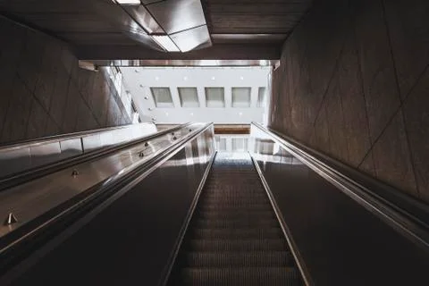 Escalator stairs going up towards the exit Stock Photos