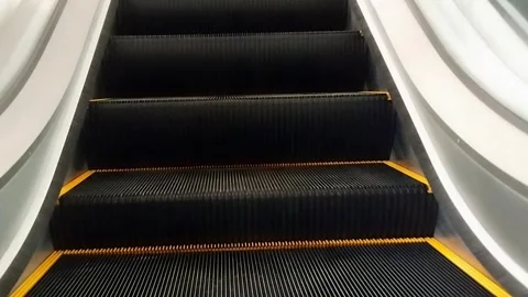 Escalator Steps and Yellow Lines in Modern Public Transportation Hub Stock Footage 311575281