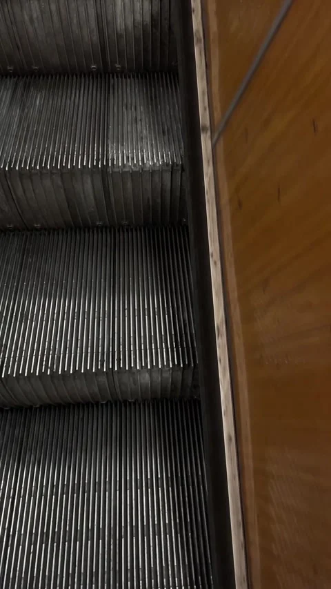 Escalator steps made of coarse textured metal within urban public spaces Stock Footage 335367828