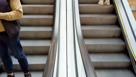 Escalator steps moving up and down inside shopping center. People in shopping Stock Footage 219487783