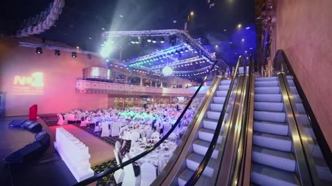 Escalator to top level of event hall with served tables during Award Records of Stock Footage 276371844
