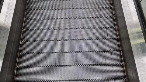 Escalator, top view. Moving an escalator up in a public place Stock Footage 250351378