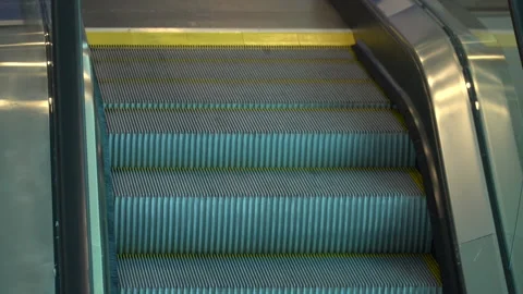 An escalator with yellow stripes moves from bottom to top Stock Footage 256256602