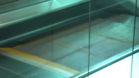 An escalator with yellow stripes moves from bottom to top Stock Footage 256259241