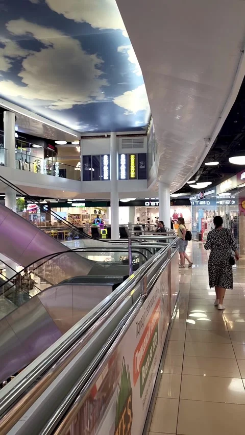 Escalators and storefronts inside a modern shopping mall Stock Footage 343732644