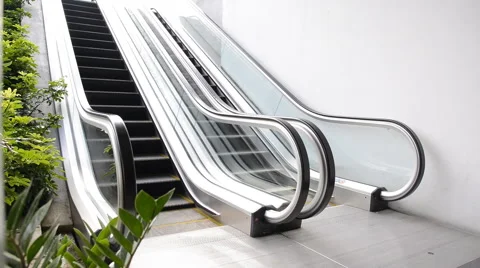 Escalators are shown that constantly run, which moves to basement floor Stock Footage 41871482