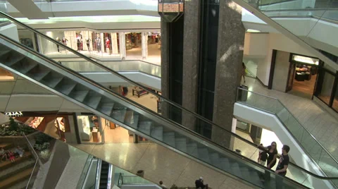Escalators ascending with people while elevator descends within mall (1 of 2) Stock Footage 32327004