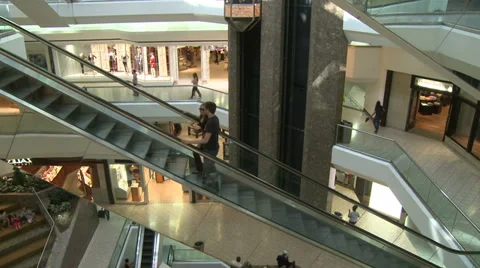 Escalators ascending with people while elevator descends within mall (2 of 2) Stock Footage 32327005