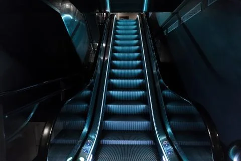 Escalators with blue light Stock Photos
