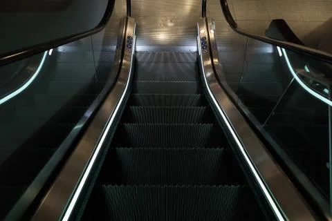 Escalators with blue light Stock Photos