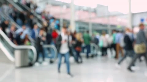 Escalators in a convention hall being used by blurred crowd of people Stock Footage 154946787