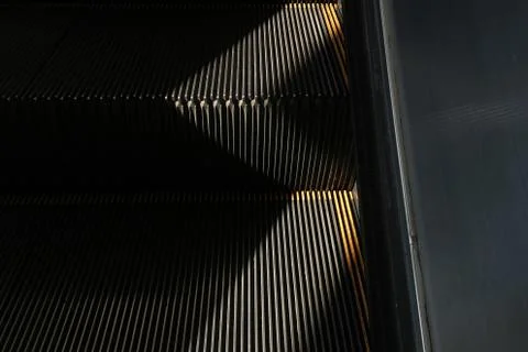 Escalators line abstract pattern against light background. Stock Photos