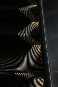Escalators line abstract pattern against light background. Stock Photos